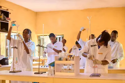 Students carrying out titration and filtration practicals in the chemistry laboratory