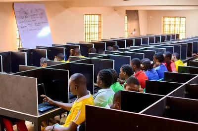 Students working at laptops in the school computer and CBT practical hall